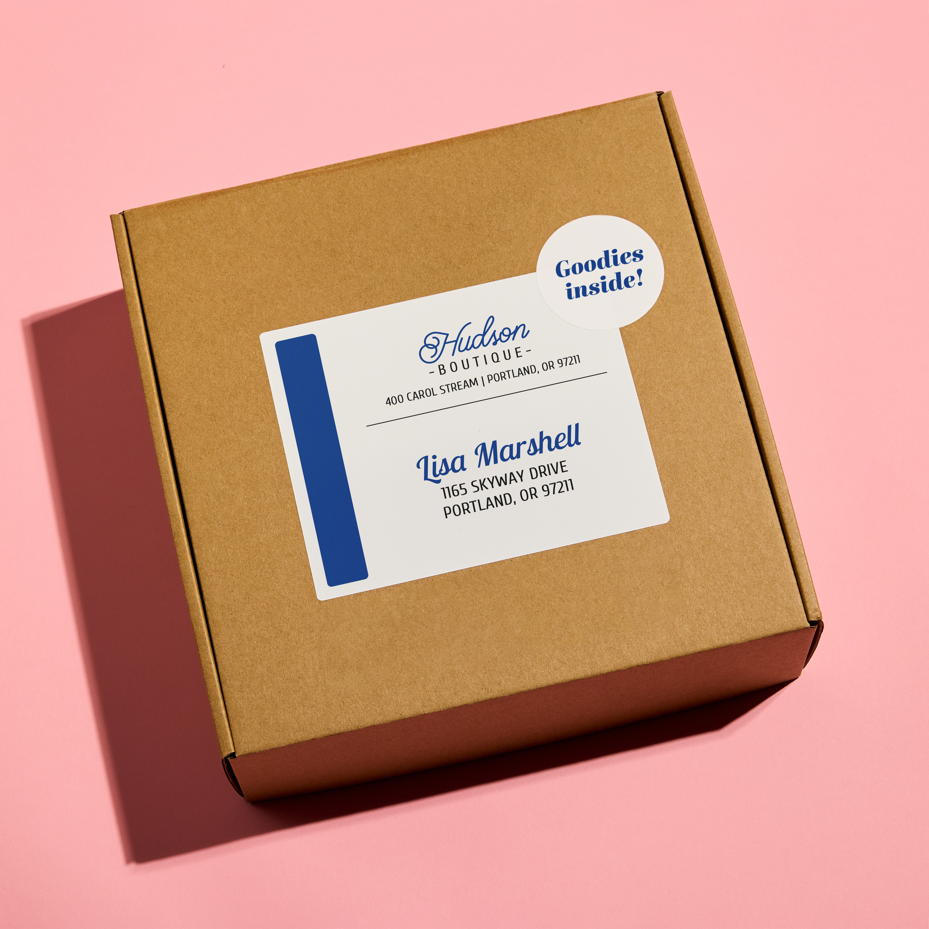 Brown kraft shipping box featuring a clean, professional Avery 8154/5164 address label in white with navy accents and a “Goodies Inside!” sticker—used as everyday branded packaging.