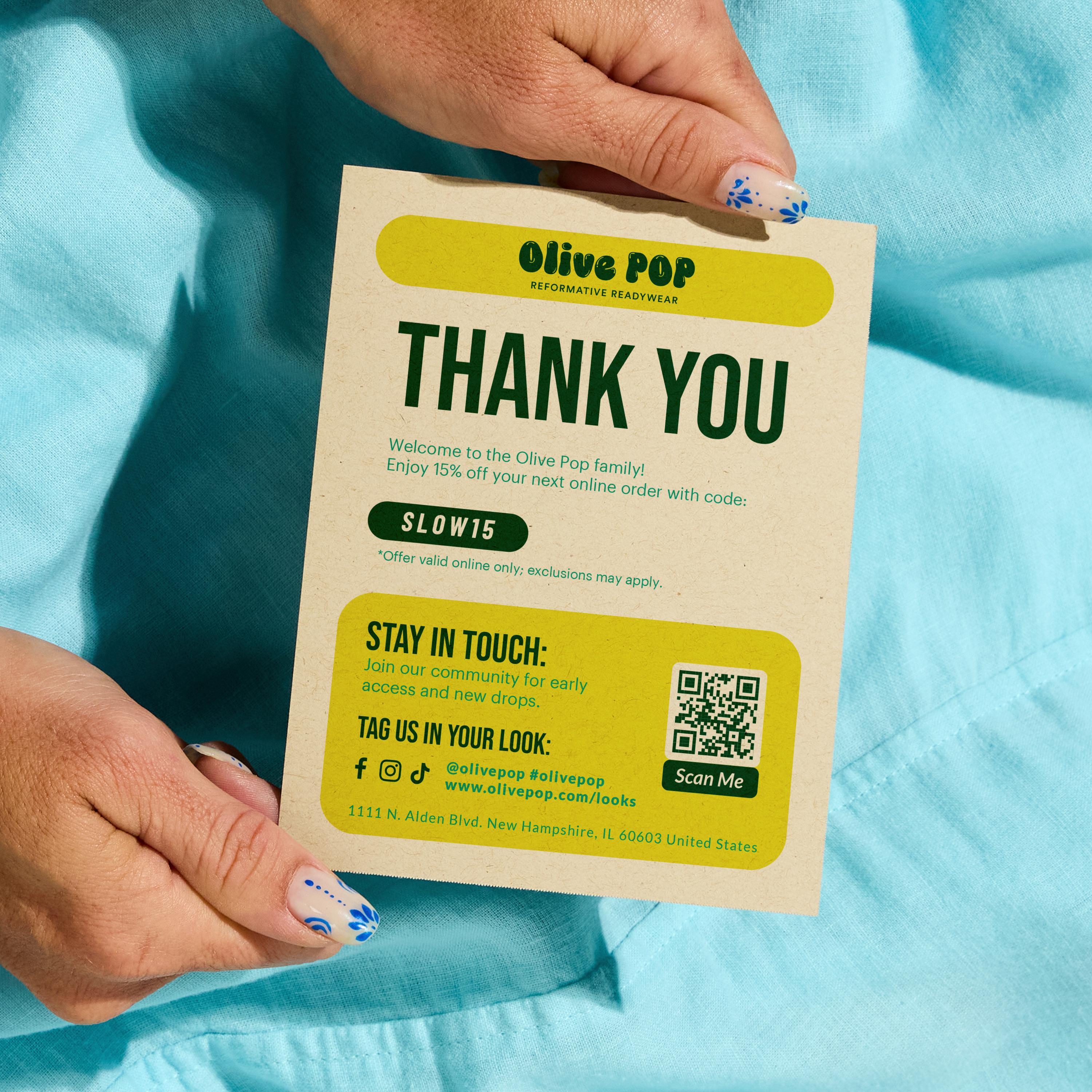 Hands hold a thank-you postcard printed on Kraft brown recycled paper, featuring QR codes and a brand message—an example of small business marketing tools with sustainability in mind.