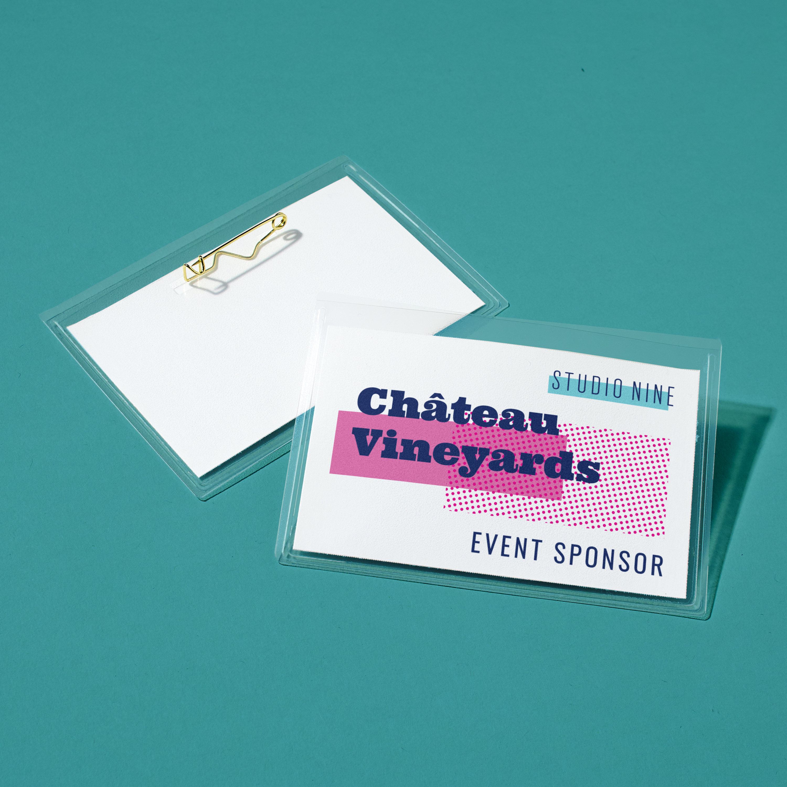 Event sponsor name tag idea for conferences. Rectangular pin-style badge reads “Château Vineyards, Event Sponsor” with magenta and navy design on teal background.