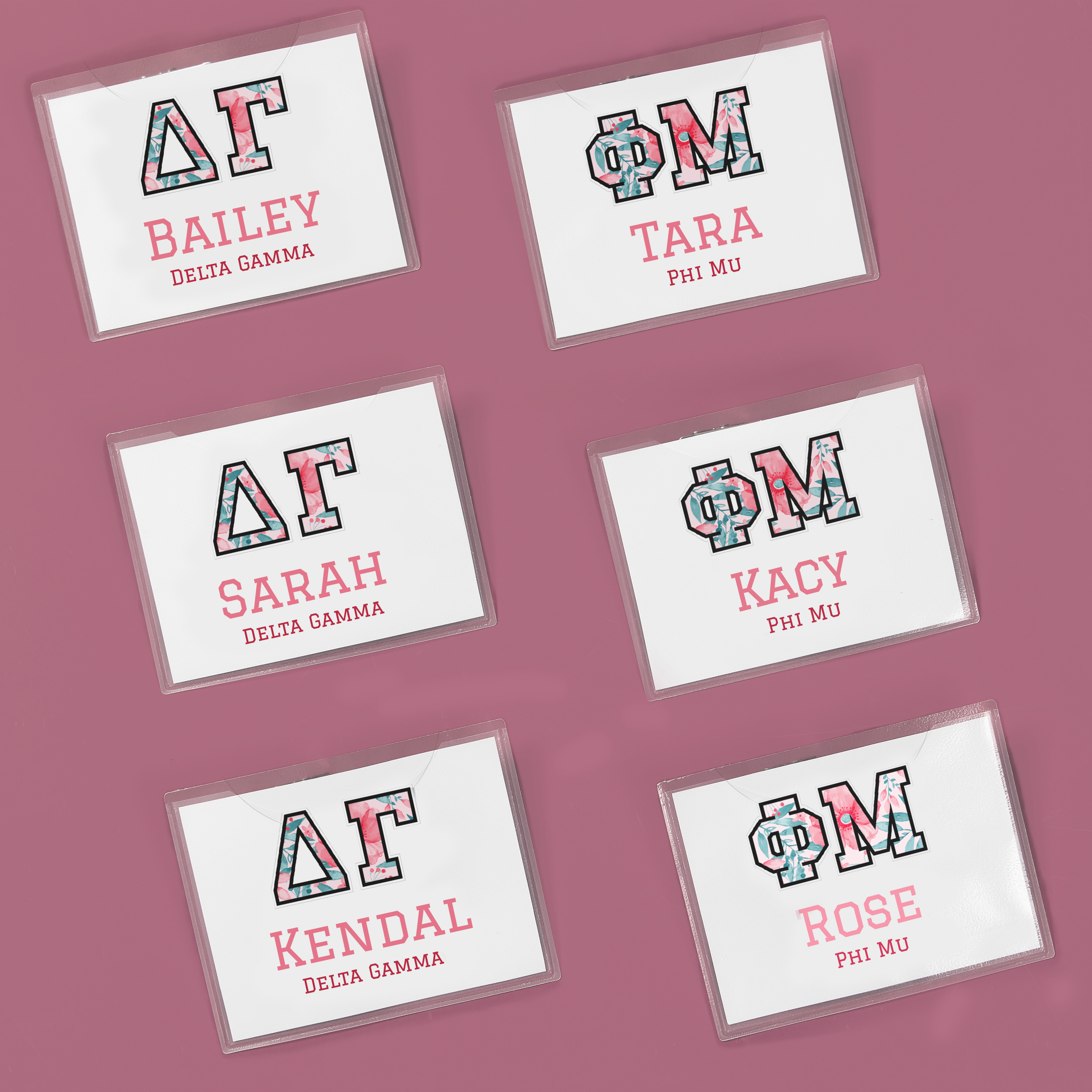 Fun and floral sorority name tags for school. The design features floral Greek letter graphics for different sororities and pink font with the person's name.