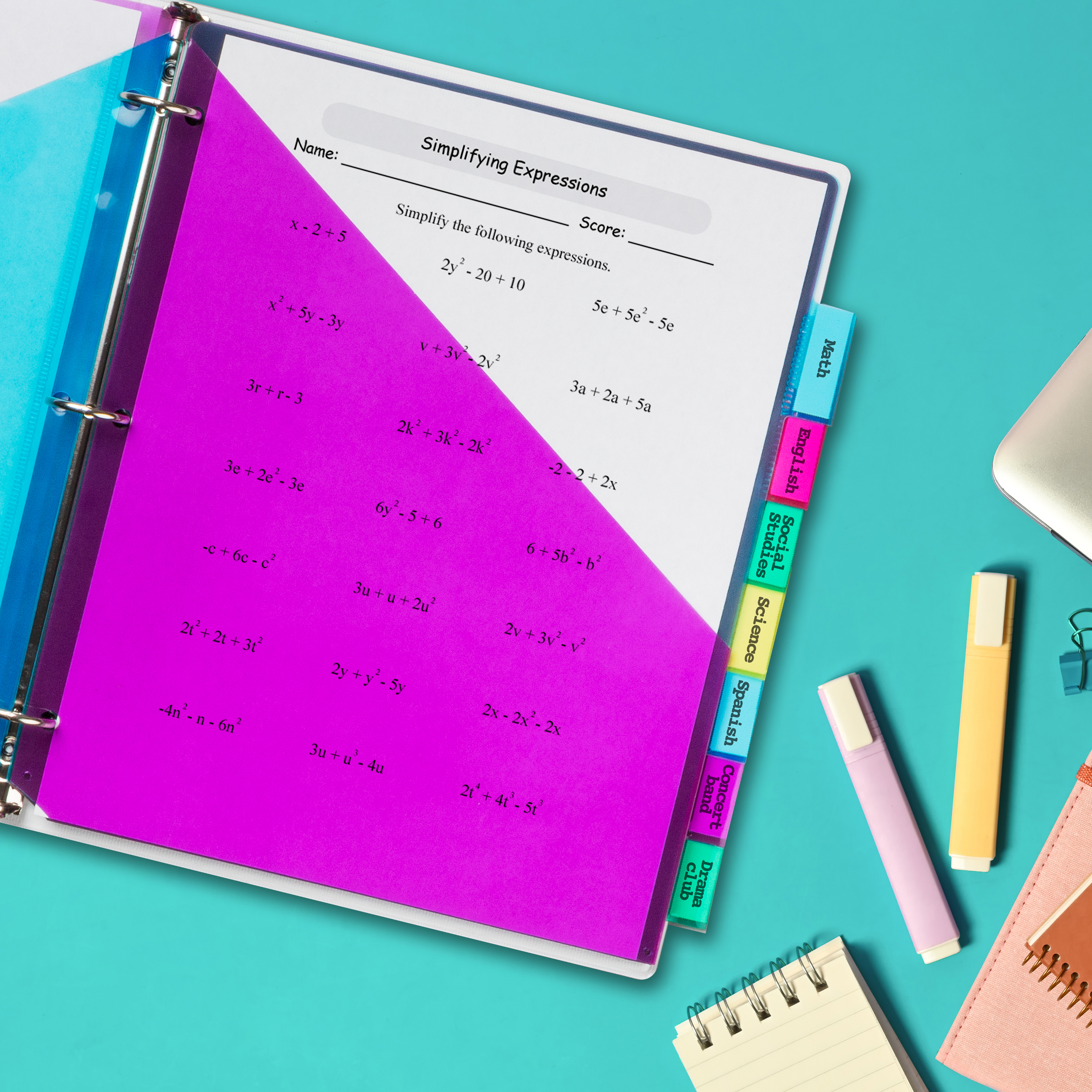 A top-down image of an open binder on a teal blue desk. The binder is surrounded by back-to-school supplies. Inside the binder are colorful Avery 11989 pocket dividers. 