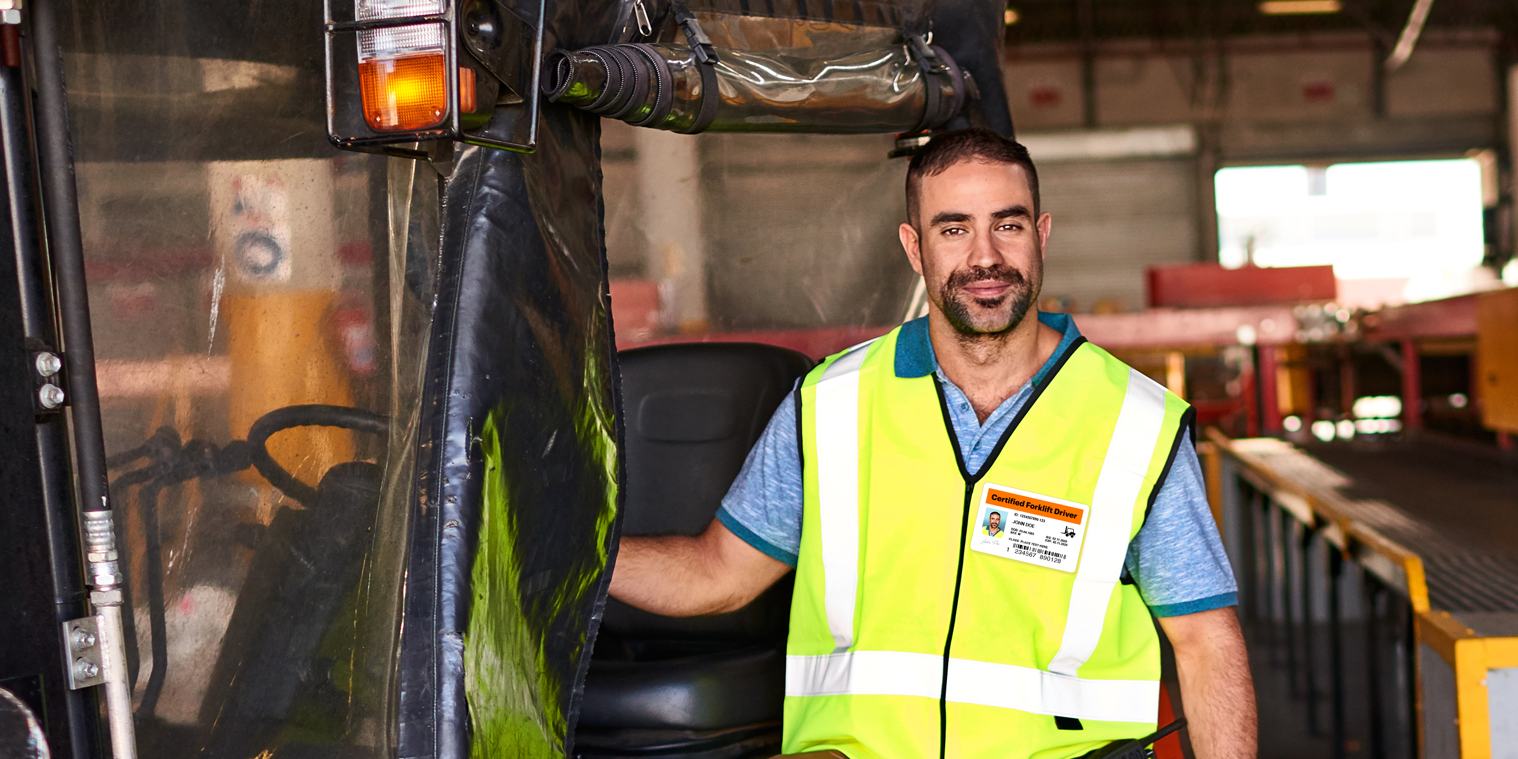 Image of warehouse worker driving a powered industrial truck forklift. Worker is wearing a certified forklift driver employee ID badge made with an Avery ID badge template.