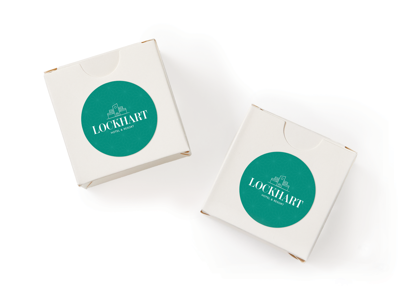 Two boxes labeled with round Avery labels printed with a green design